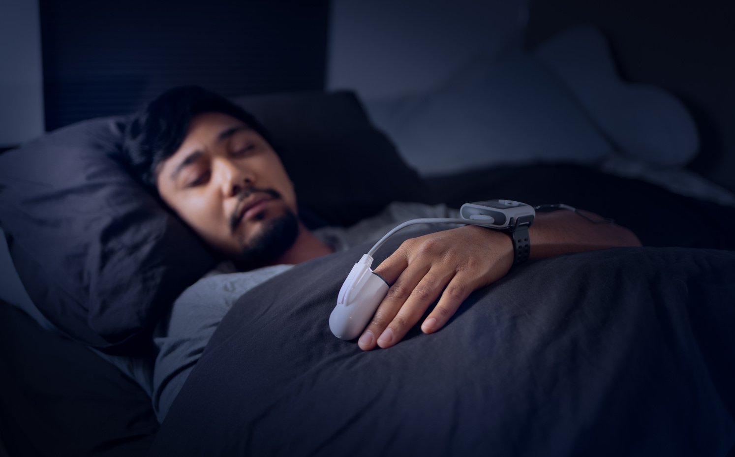 Man Wearing a Pulse Oximeter - At Home Sleep Study Test for Sleep Apnea